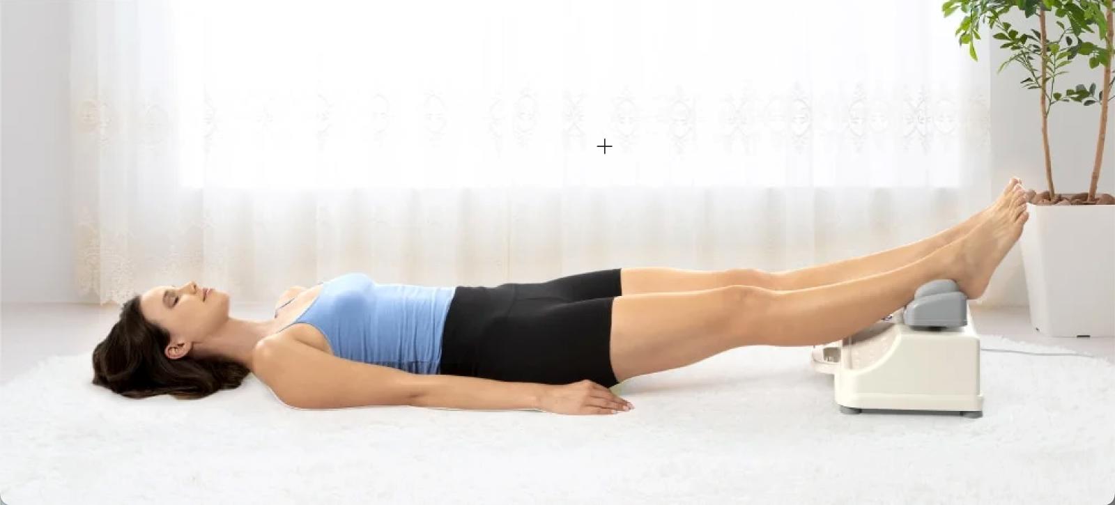 woman laying down with ankles resting on the chi machine